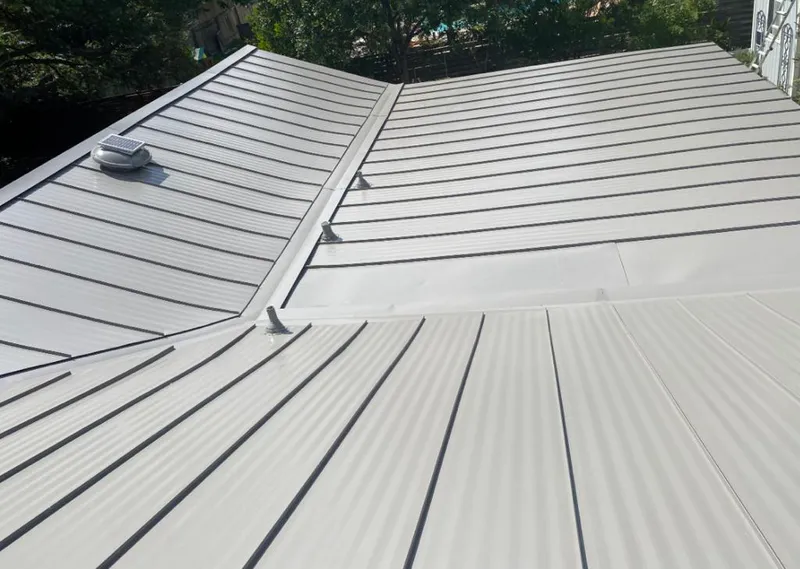 Solar attic fan installed on a metal roof for Roof Ventilation in Pebble Creek